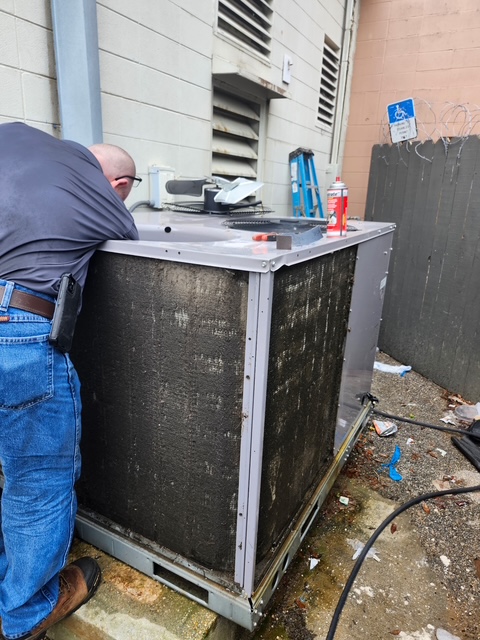 Outdoor HVAC equipment next to a building wall