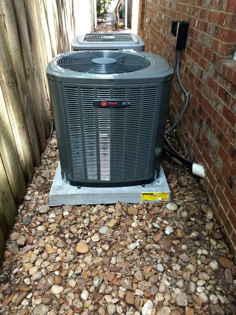 Outdoor air conditioning condenser unit on a gravel pad