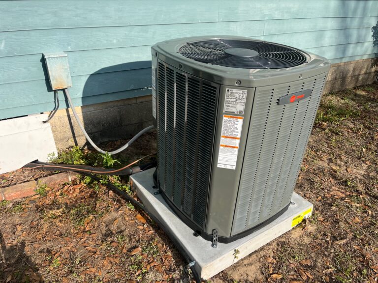 Outdoor condenser unit next to a home or light commercial building