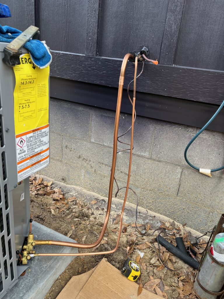 Ground-level piping or utility installation next to a structure