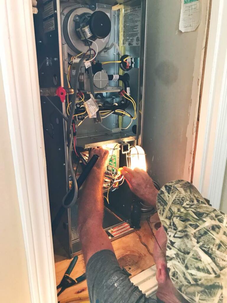 Technician servicing electrical or mechanical equipment indoors