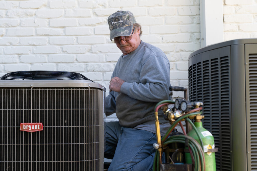 technician fixing ac